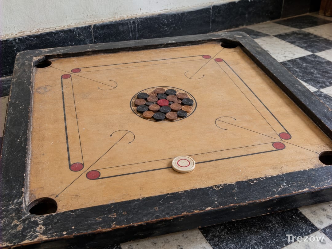 Carrom board with coins, striker