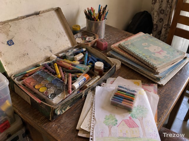 Art supplies box with school notebooks