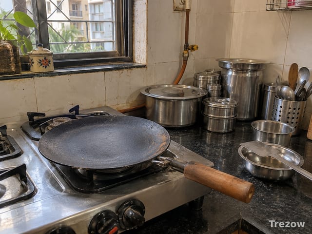 Cast iron tawa with steel utensils
